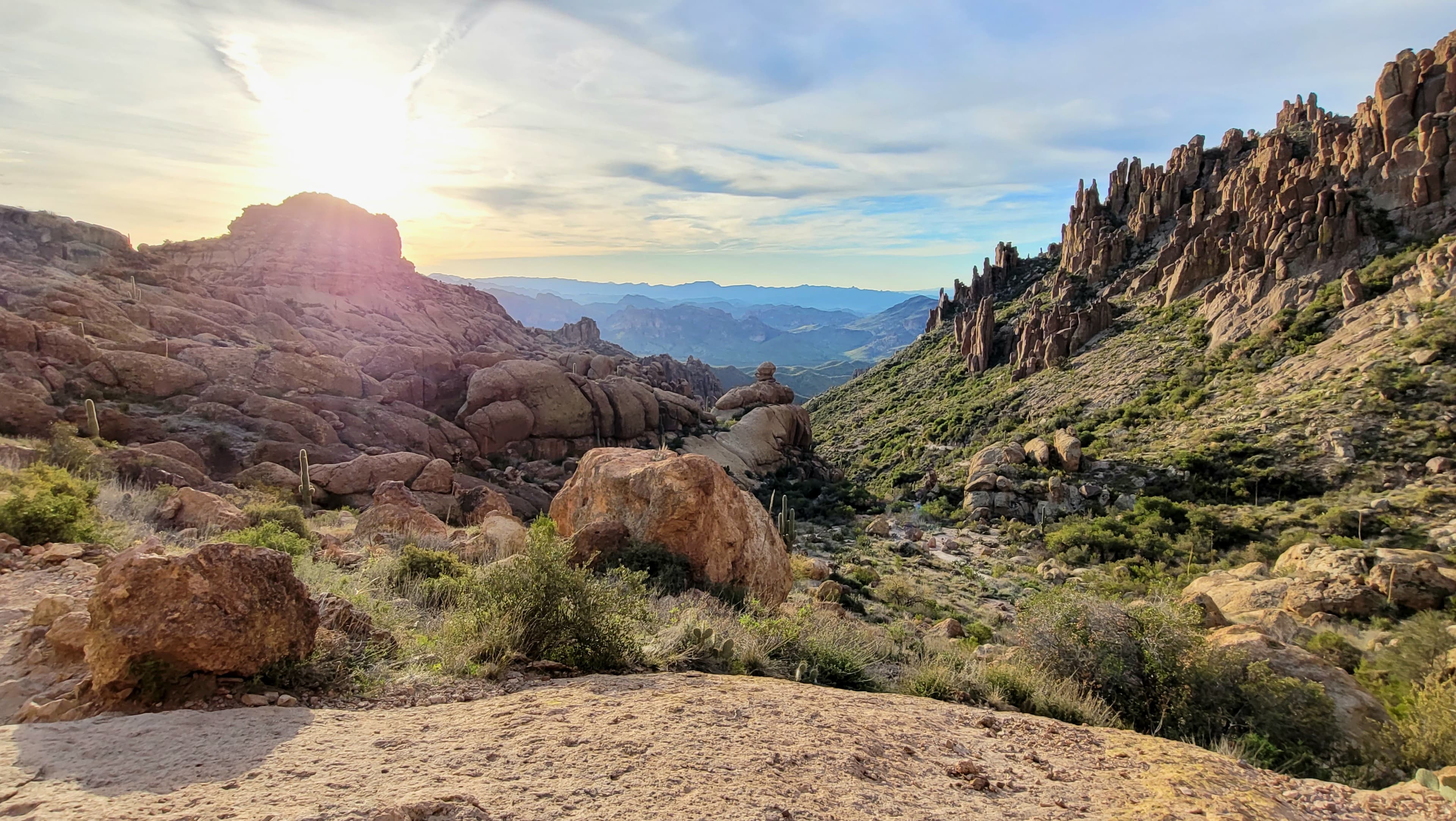 A serene desert awakening where ancient rock formations catch the first gentle light in pristine wilderness solitude.